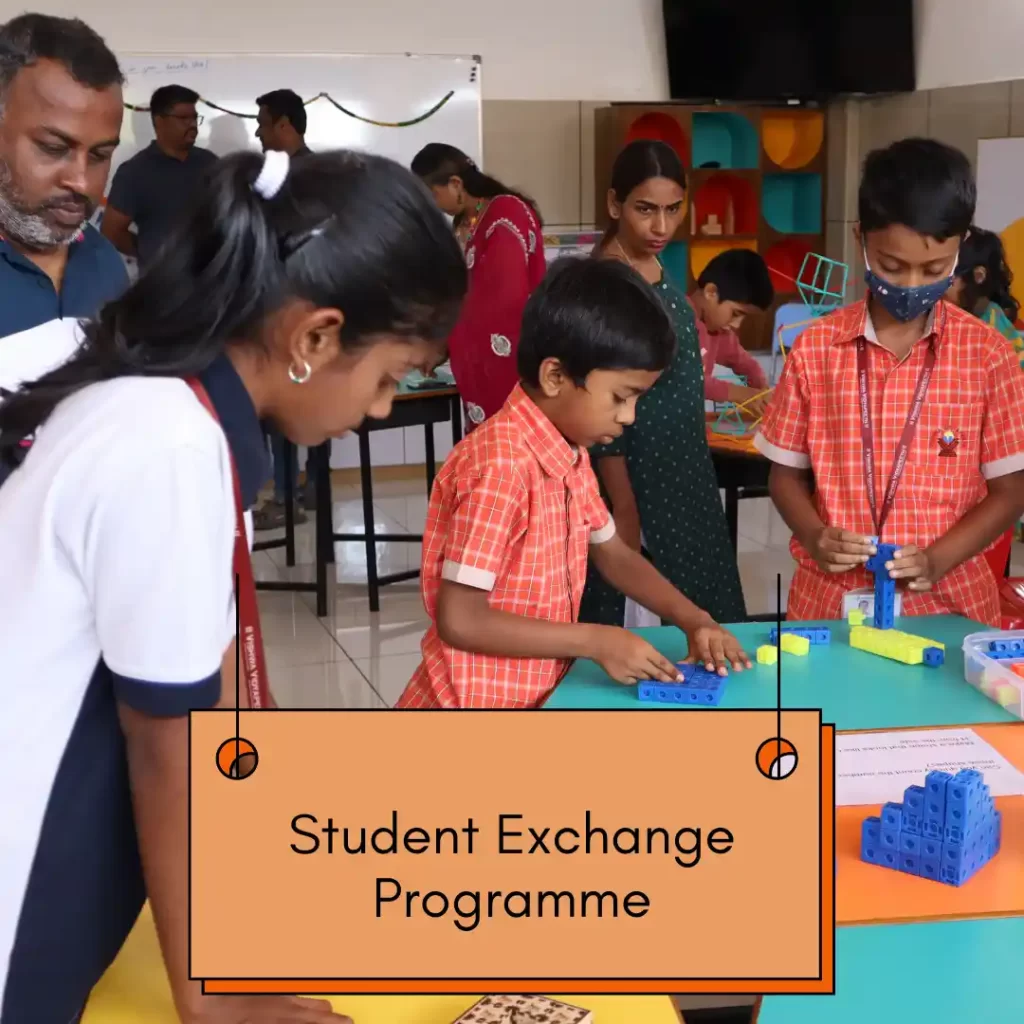 Children working on classroom activities at a table; label reads ‘Student Exchange Programme.’