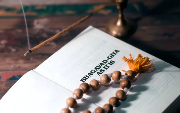 depositphotos_415019236-stock-photo-bhagavad-gita-rosary-lying-wooden