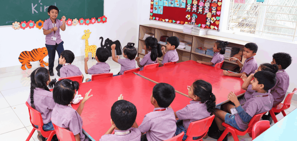 Teacher engaging young students seated in a circle during an interactive classroom activity.