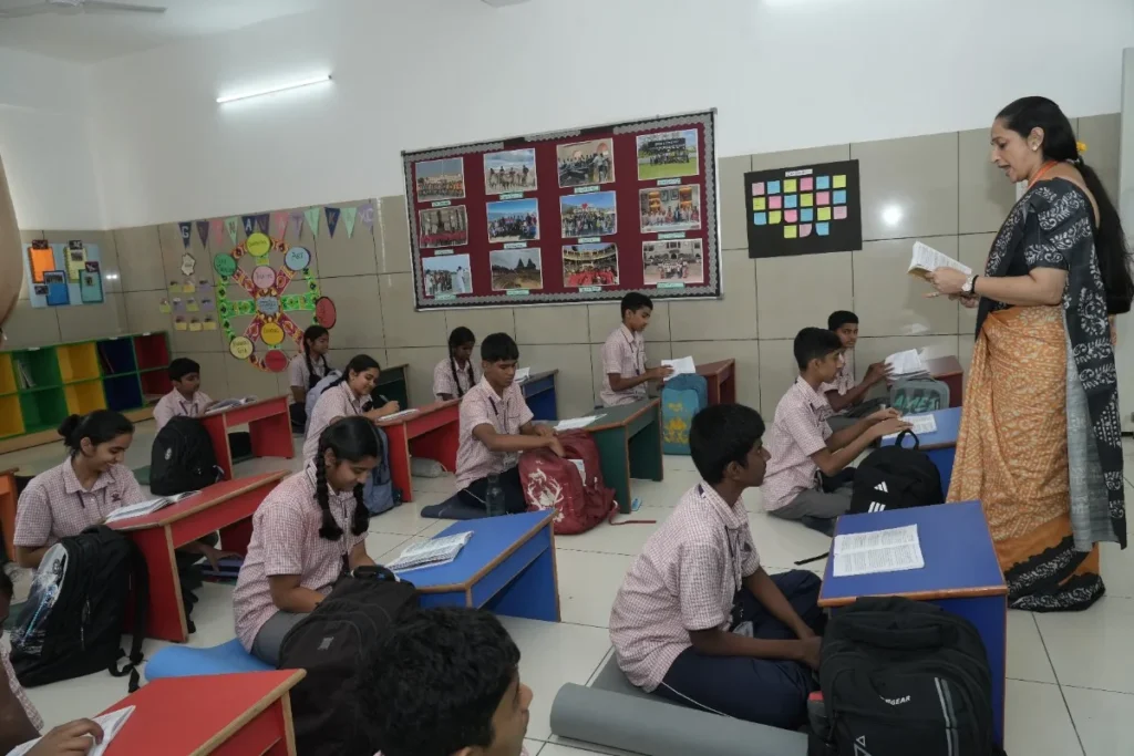 Teacher conducting an interactive classroom lesson with young school students seated at their desks, creating an engaging and collaborative learning environment.